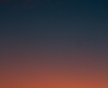 Fiery sunset with crescent moon Crescent moon and fiery orange sunset horizon